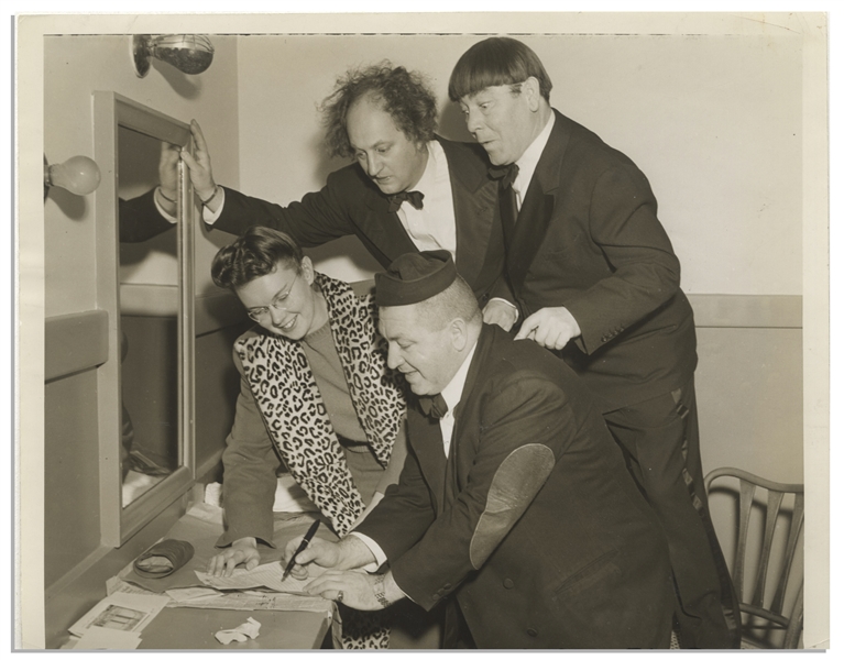 Moe Howard Personally Owned 10'' x 8'' Glossy Photo From 1939 of Curly, Moe & Larry Hamming It Up While Signing an Autograph -- Very Good Condition